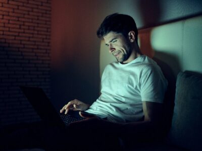 Man Works Late on Laptop in his Room