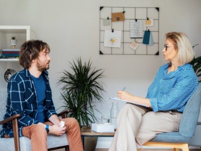 male patient having psychotherapy session with counselor